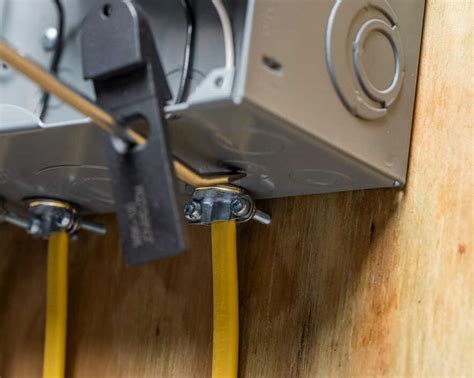 cutting a hole through metal breaker box|knockout holes in electrical panel.